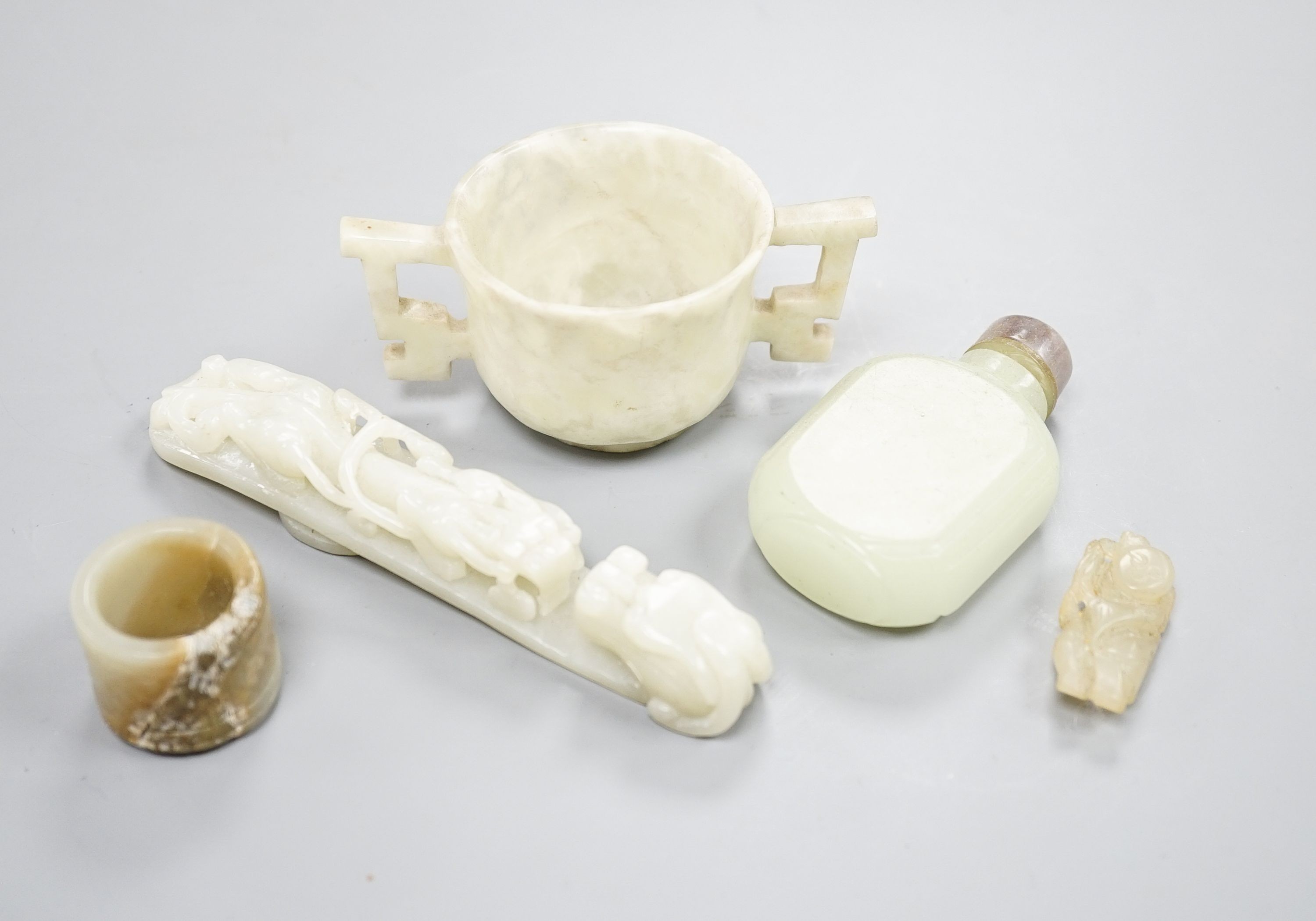 A Chinese jade belt hook, 12.5cm an archer's ring and figure, a stone cup and a glass snuff bottle
